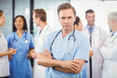 Male doctor standing with arms crossed