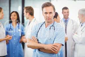 Male doctor standing with arms crossed