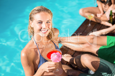 Beautiful young woman having cocktail