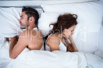High angle view of angry couple on bed