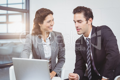 Happy business people using laptop