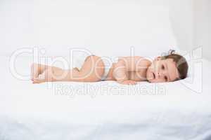 Portrait of baby lying on bed