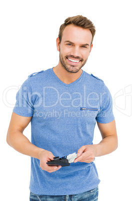 Young man removing money from his wallet