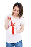 Young woman opening a present