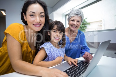 Happy family interacting using laptop