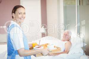 Portrait of confident nurse with tray