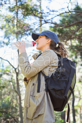 Woman drinking water while doing a break