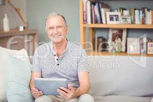 Portrait of senior man using digital tablet