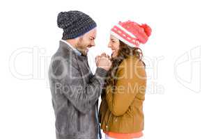 Young couple in warm cloth standing face to face and shivering