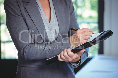 Businesswoman taking notes