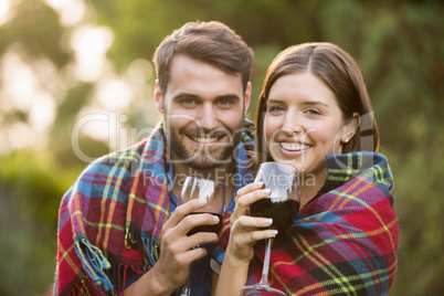 Portrait of smiling couple wrapped in blanket