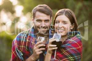 Portrait of smiling couple wrapped in blanket