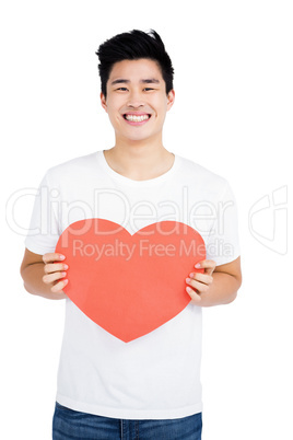 Young man holding a heart shape