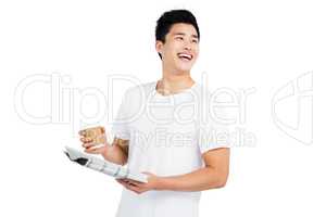 Young man having coffee and reading newspaper