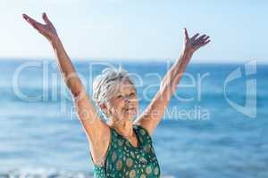 Senior woman raising arms