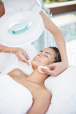 Young woman receiving facial massage