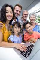 Happy family interacting using laptop