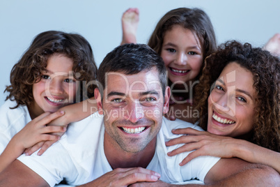 Portrait of a family lying on bed