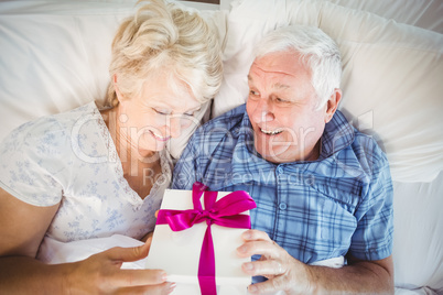 High angle view of senior man giving wife gift