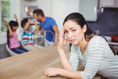 Portrait of tensed mother at table