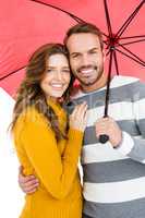 Happy young couple holding pink umbrella