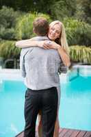 Happy young woman with eyes closed while hugging man