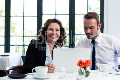 Business colleagues using a laptop while having a meeting