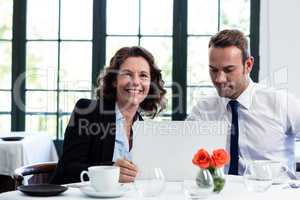 Business colleagues using a laptop while having a meeting