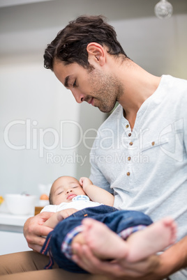 Father holding sleeping baby