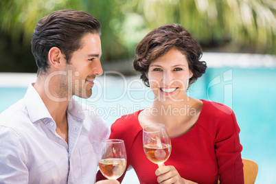 Smiling couple holding white wine