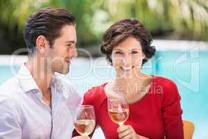 Smiling couple holding white wine