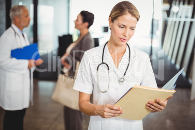 Female doctor reading a medical report