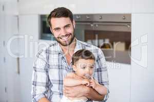 Man smiling while carrying son