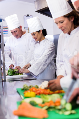 Team of chefs chopping vegetables