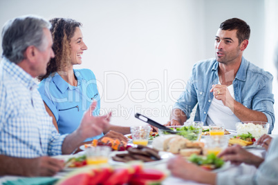 Happy family talking while having breakfast