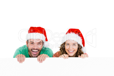 Happy young couple wearing santa hat