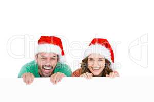 Happy young couple wearing santa hat