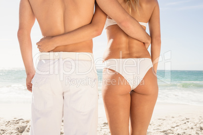 Young couple in beachwear embracing