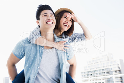 Young man giving a piggyback ride to woman