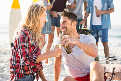 Couple sitting on sand at the beach