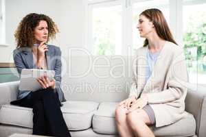Concentrated female psychologist listening to patient