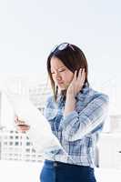 Young woman looking at map for direction