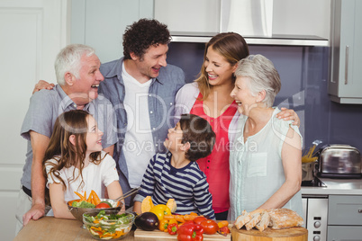 Happy family standing in kitchen