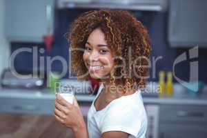 Portrait of cheerful woman with glass of milk
