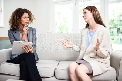 Young woman explaining problems to psychologist