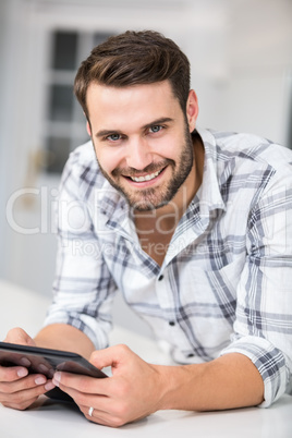 Portrait of handsome man using digital tablet