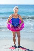 Senior woman with beach equipment