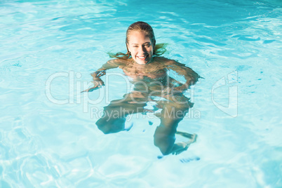 Beautiful woman swimming in swimming pool