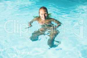 Beautiful woman swimming in swimming pool