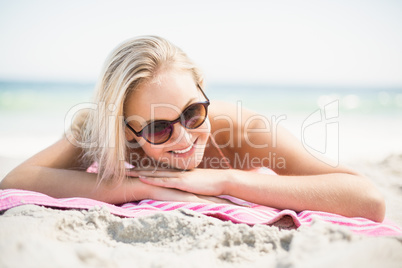 Pretty woman in bikini lying on the beach